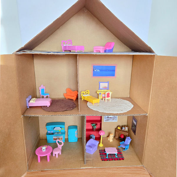 cardboard doll house filled with mini furnishings