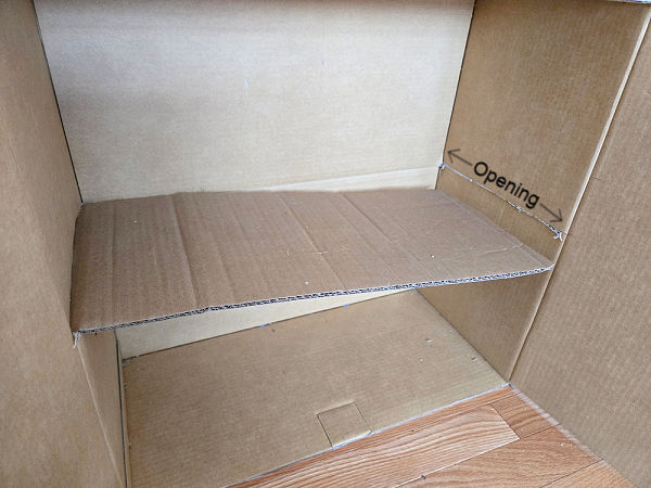 pice of cardboard inserted in the sides of the box to make the floor of the doll house
