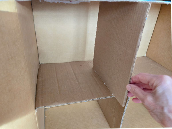 slide a piece of cardboard into the doll house to make dividing wall