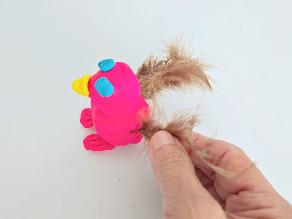 playdough bird craft with small feathers