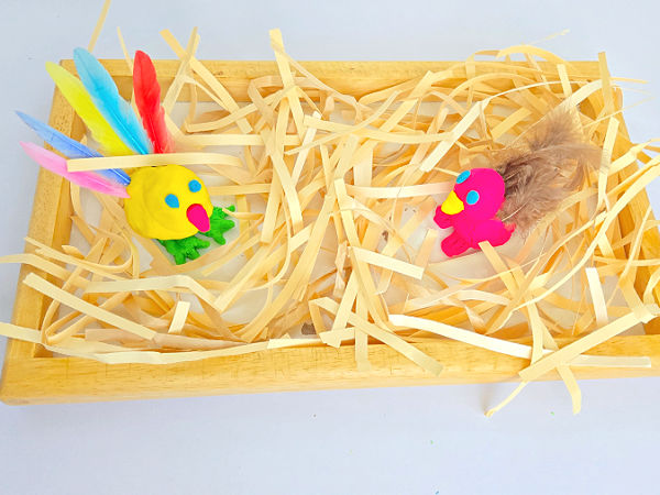 playdough birds in nest made with shredded paper