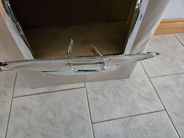 open and close the cardboard oven door