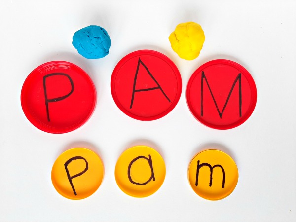 Print letters inside jar lids for a preschool literacy activity