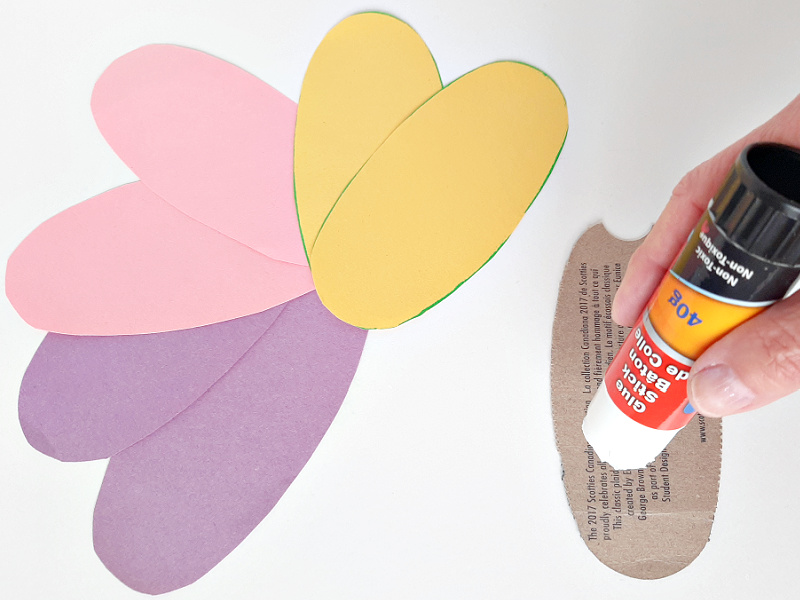 Glue construction paper egg shapes to cardboard