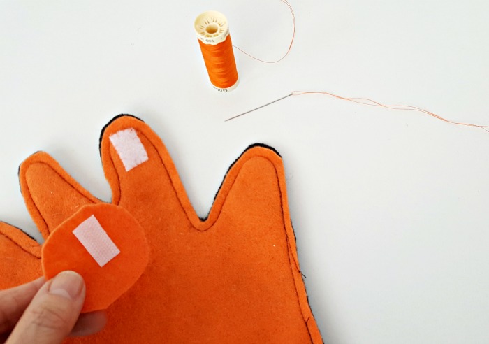 Sew hook and loop closure to finger play glove