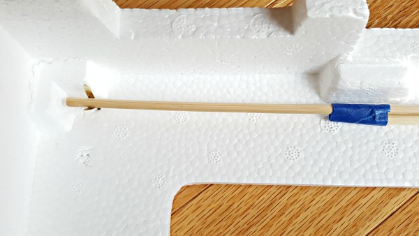 Attach curtain rod to back of puppet theater