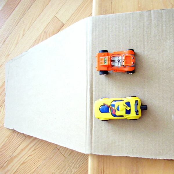 experiment with a cardboard inclined plane and toy cars