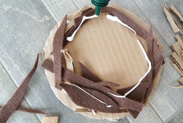 layer felt and feathers to make a bird nest craft
