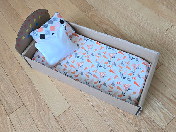 doll bed with foam mattress and two pillows