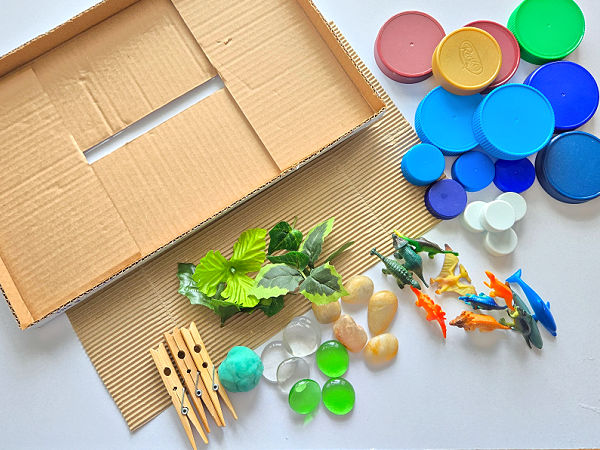 create a dinosaur habitat in a cardboard dbox