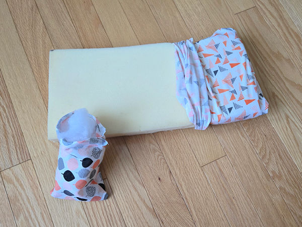 foam mattress covered with fabric to make a kids doll bed