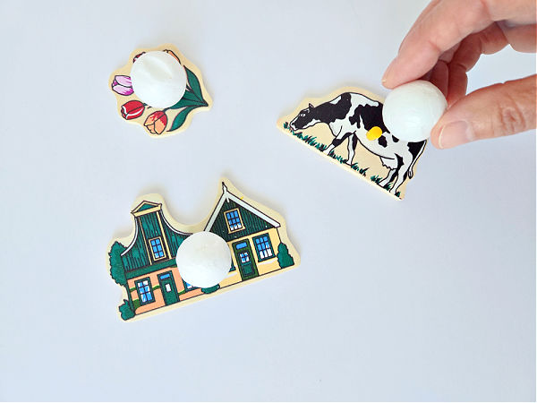 glue handles onto wood puzzle pieces for a preschool art activity