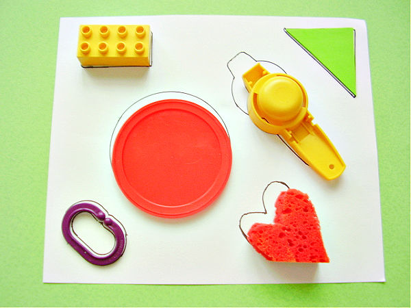 kids math activity matching objects to outline traced on paper