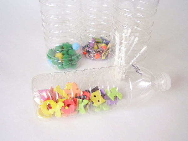 recycled water bottle filled with small parts for a sense of hearing activity
